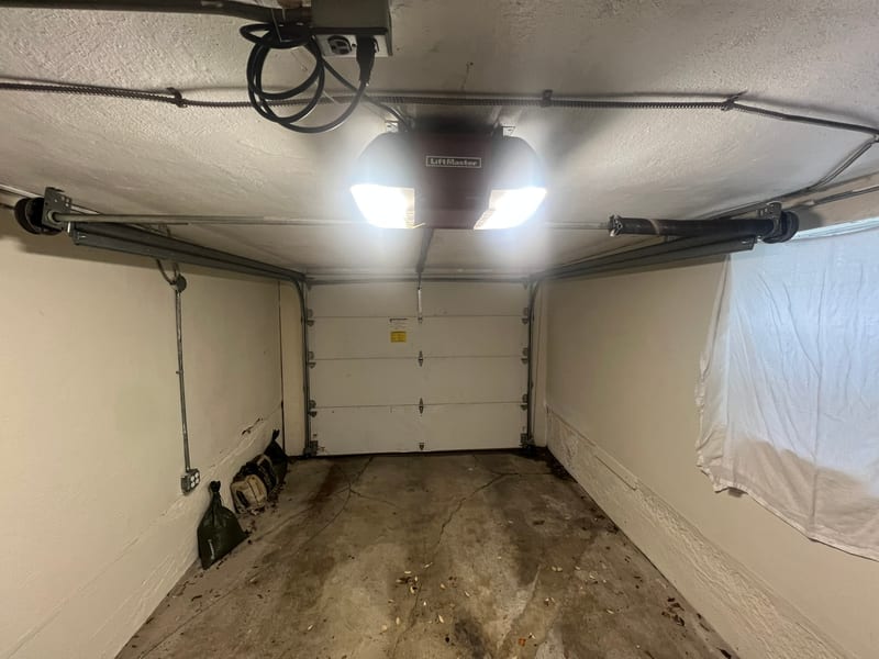 Garage door opener and door seen from inside a garage