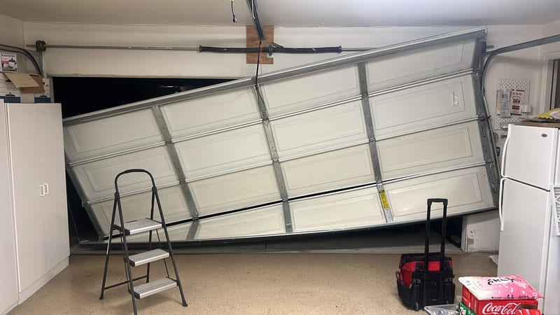Garage door with a damaged section, mid-repair